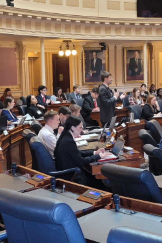 Riley Johnson clarifying the bill and requesting for an  amendment (Riley standing addressing the Majority Leader  off-screen, microphone in hand).